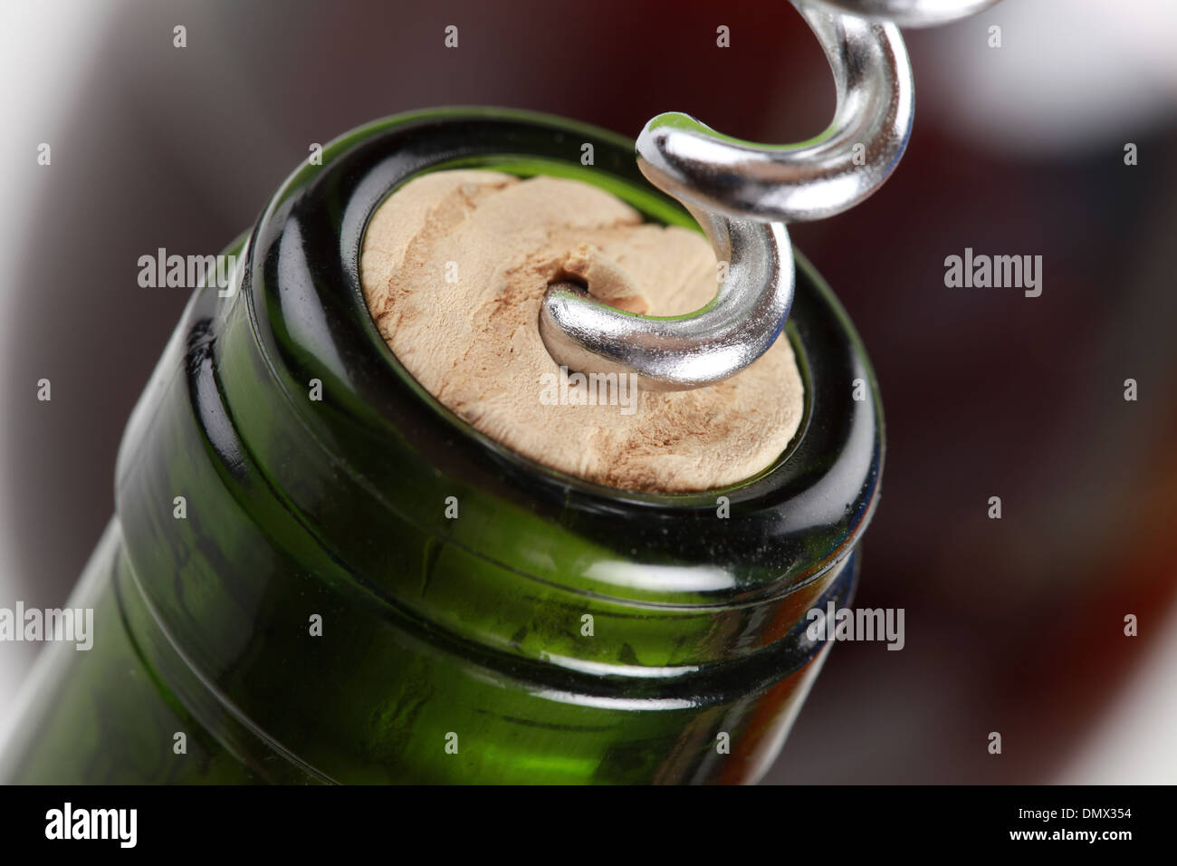 Opening a wine bottle with a corkscrew Stock Photo