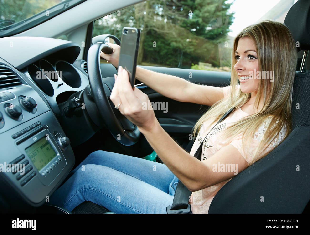 Girl taking picture of herself whilst driving Stock Photo