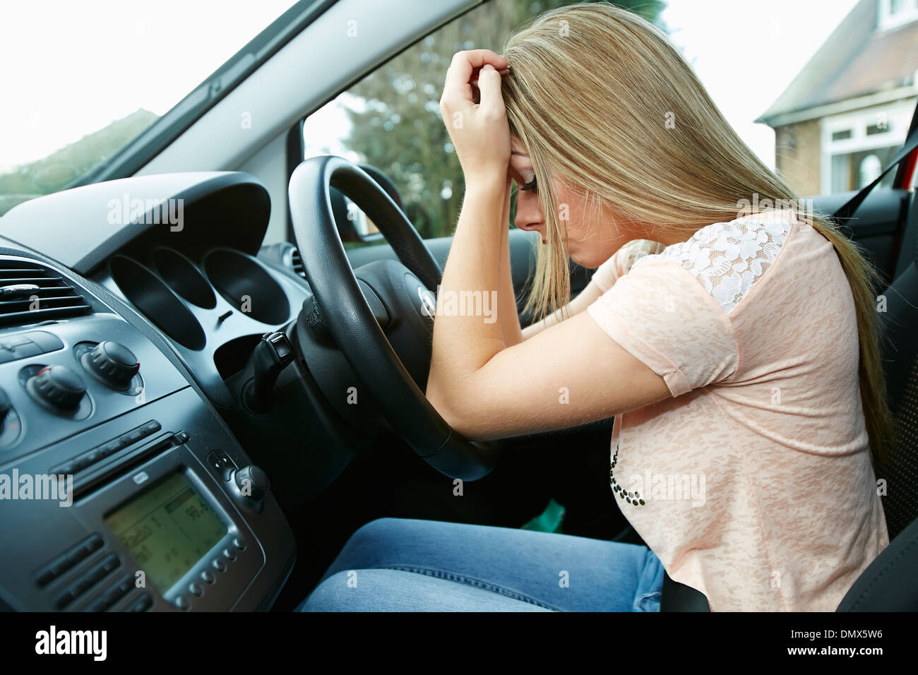 Girl driving with a headache Stock Photo