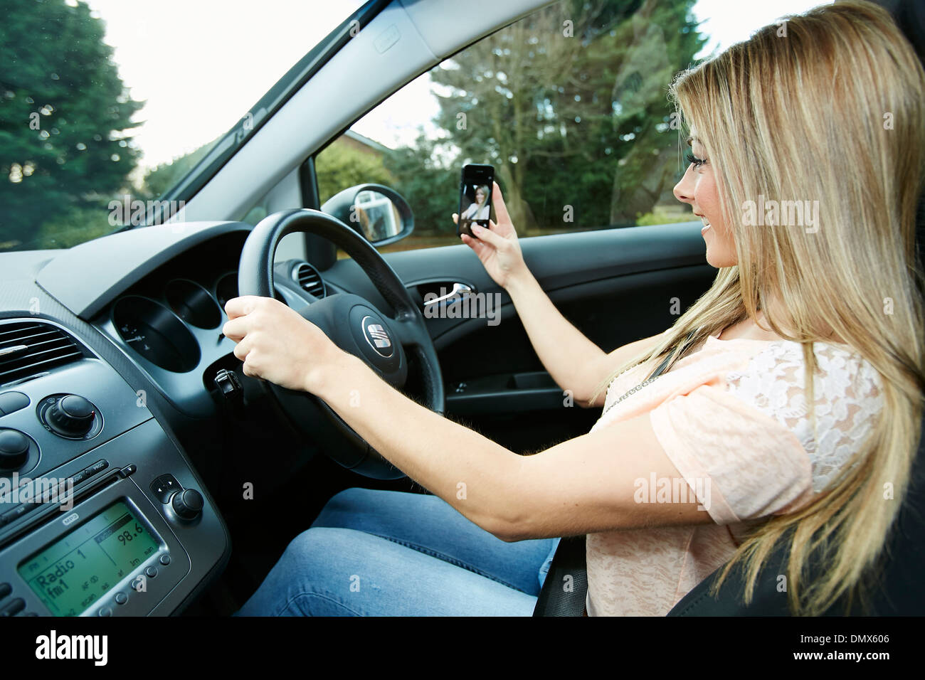 Girl taking picture of herself whilst driving Stock Photo