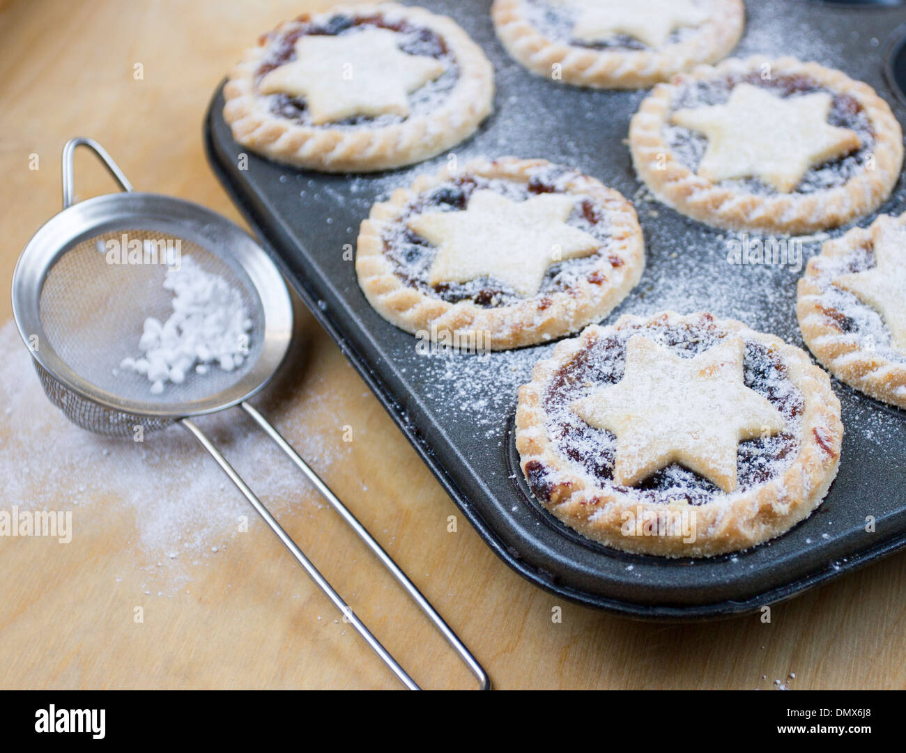Home made icing sugar dusted mince pies in baking tray Stock Photo Alamy