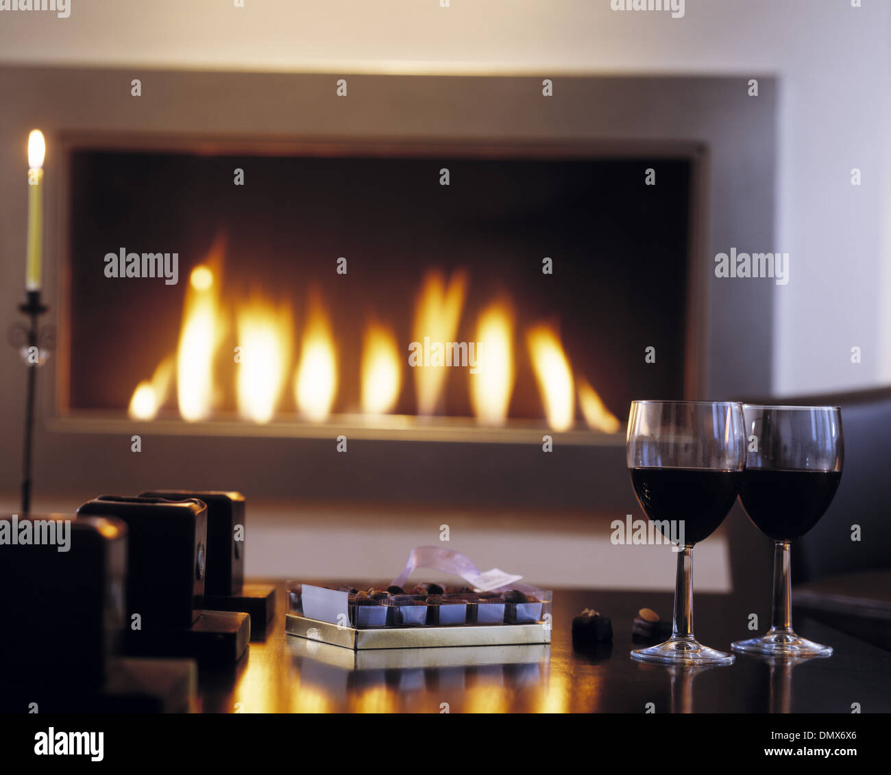 Wine and Chocolates by the fire. Stock Photo