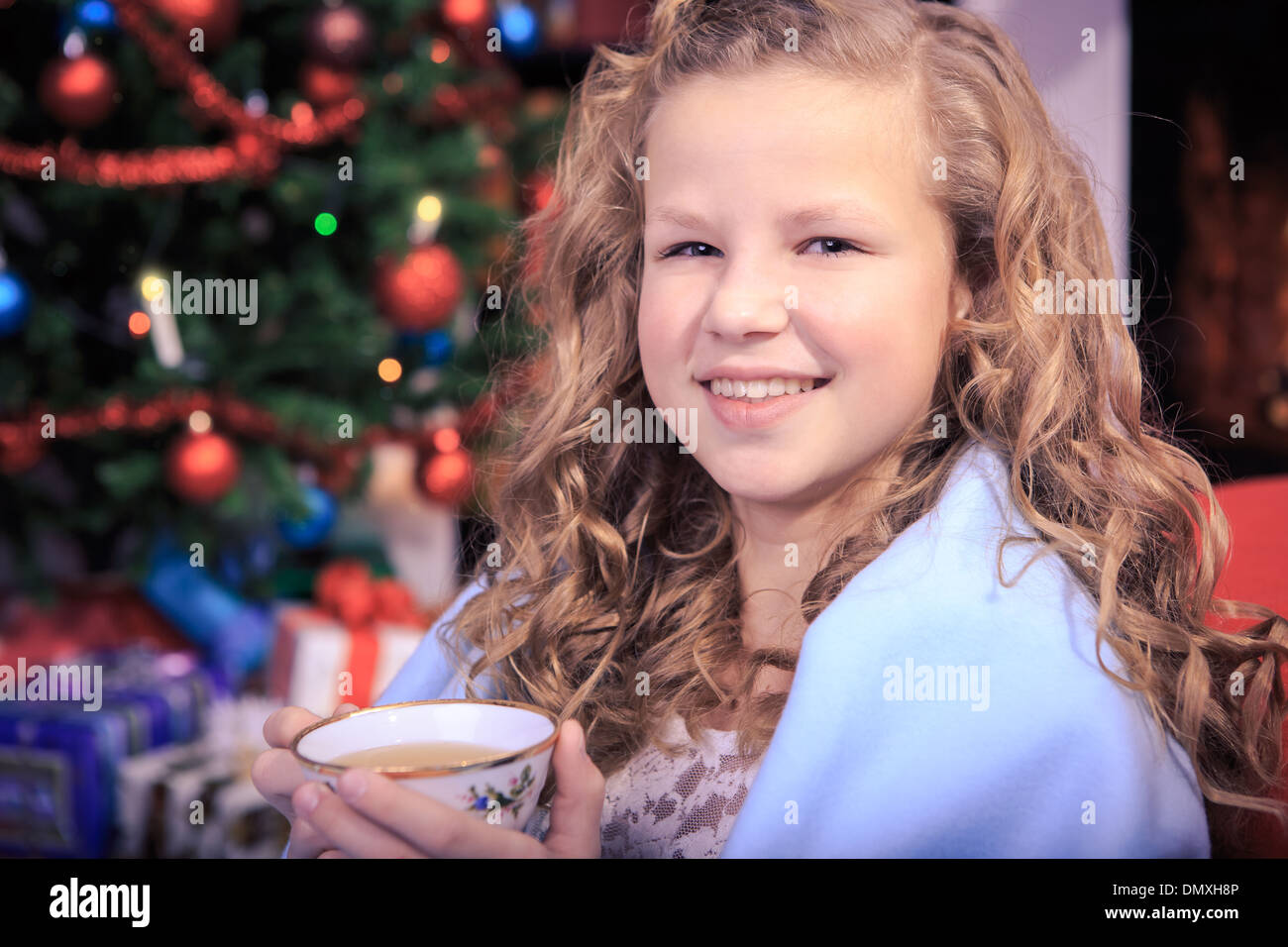 little girl drinking tea with xmas cookies at home Stock Photo