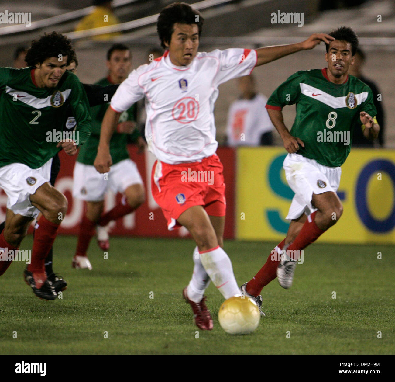 Feb 15, 2006; Los Angeles, CA, USA; SOCCER: (20)  Dong-gook Lee of the Korea Republic National Team charges with the ball while being pursued by defenders (2) Francisco Rodriguez and (8) Pavel Pardo of the National Team of Mexico during their tune up match prior to the world cup at the Los Angeles Memorial Coliseum Wednesday 15 February 2006. Korea won the game 1-0. Mandatory Credi Stock Photo