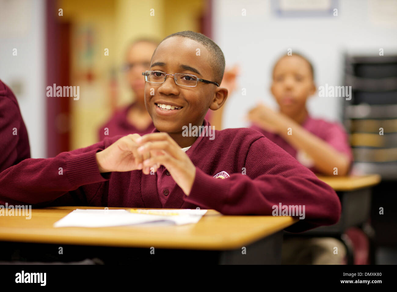 Middle school aged African American boy paying attention in class. Stock Photo