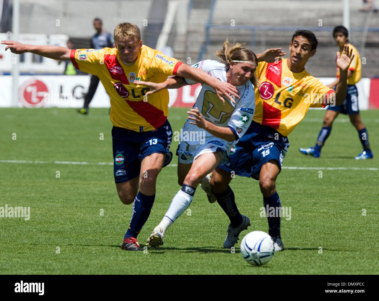 Mar 12, 2006; Mexico City, MEXICO; UNAM Pumas' midfielder Leandro Augusto  (C) fights for the ball with Morelia Monarcas' Cristian Nasuti (L) and  Fernando Arce (R) during the soccer match in the