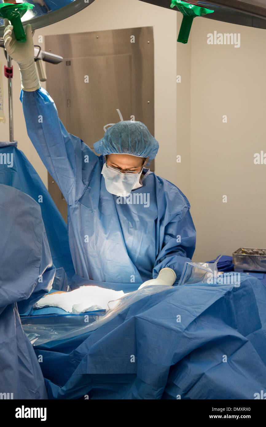 Surgeons perform a hysterectomy on a woman with endometrial cancer