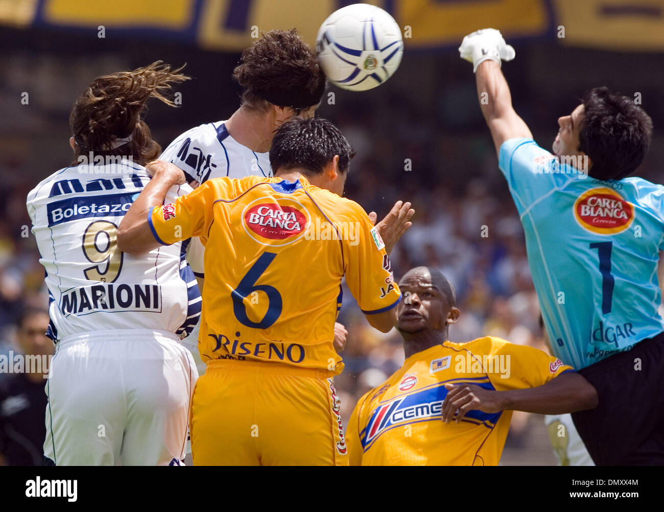 Apr 23, 2006; Mexico City, DF, MEXICO; SOCCER: UNAM Pumas forward Marco  Antonio Palacios heads the ball as UANL Tigres goalkeeper Edgar Hernandez  (R) tries to block the ball, UANL defenders Omar