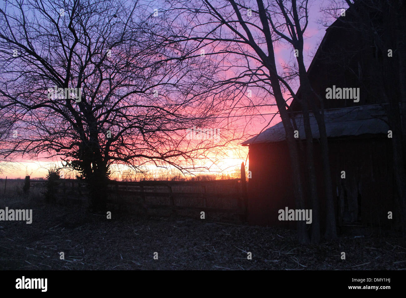 Beautiful multicolored barn sunset in the country Stock Photo