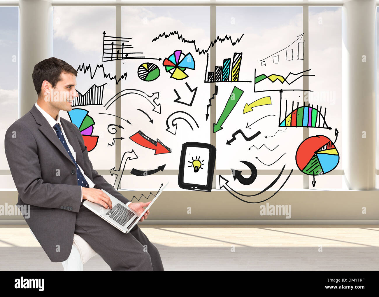 Composite image of businessman using laptop Stock Photo