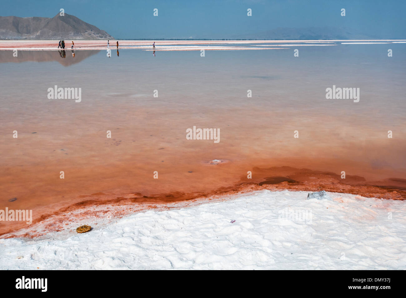 People walking in shallow waters of salt lake Urmia, West Azerbaijan province, Iran Stock Photo