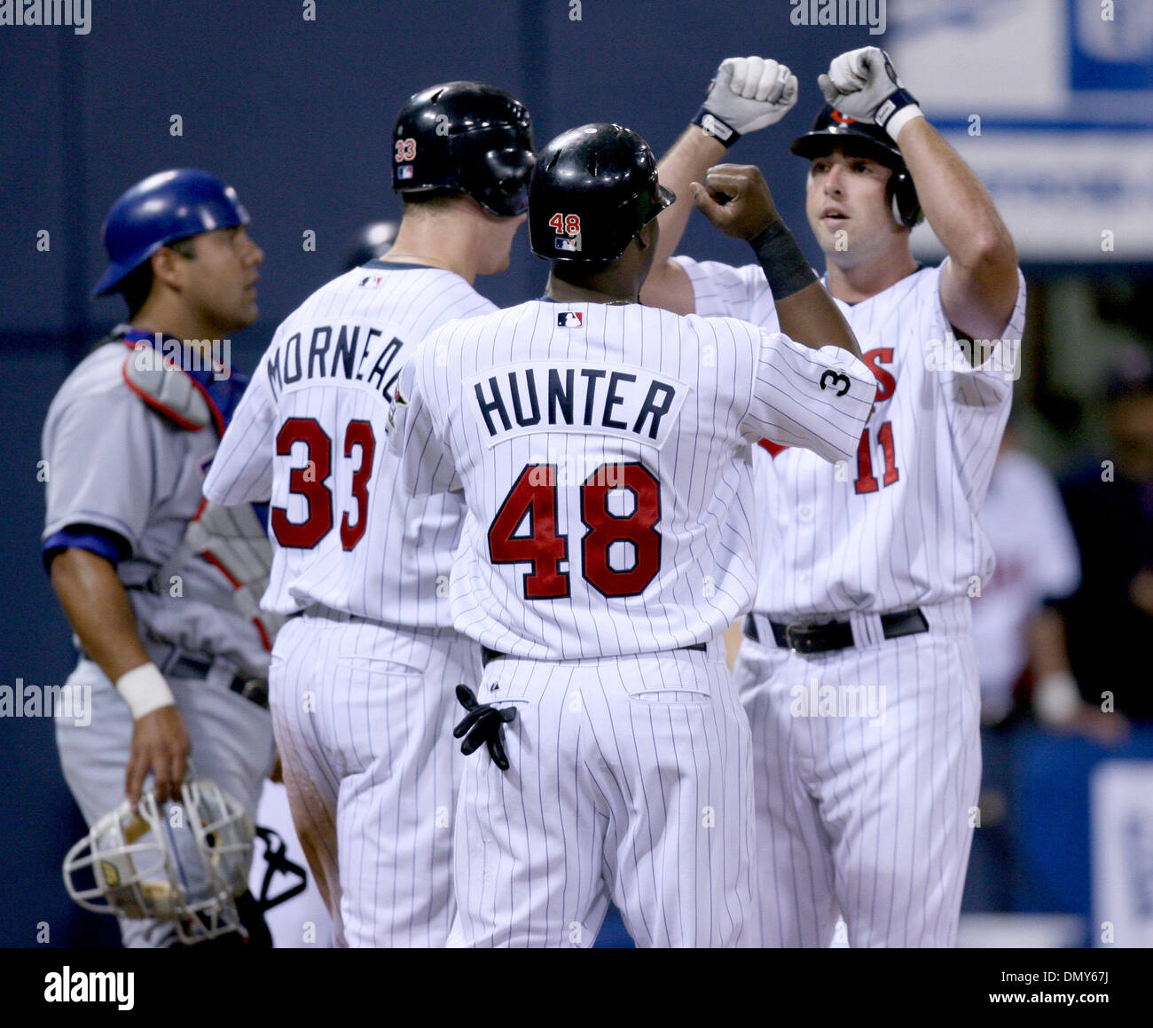 Jun 31, 2006; Minneapolis, MN, USA; Minnesota Twins' Josh Rabe (right) knocked a home run off the Texas Rangers' starter John Rheinecker to bring in Justin Morneau (left) and Torii Hunter (center) who congratulated him at the plate. The Twins defeated the Rangers 15-2 at the Metrodome in Minneapolis, Minnesota, Monday, July 31, 2006.  Mandatory Credit: Photo by Jeff Wheeler/Minneap Stock Photo