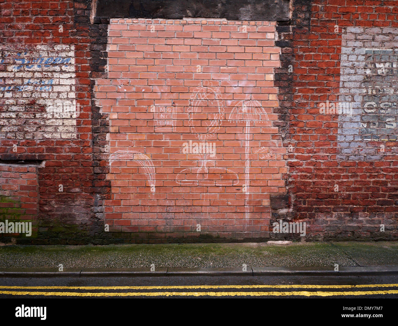 Bricked up doorway with drawing in Northern Quarter Manchester UK Stock Photo