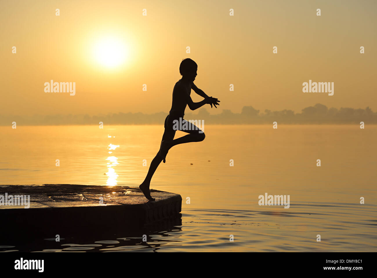 Indian boy jumping in river hires stock photography and images Alamy