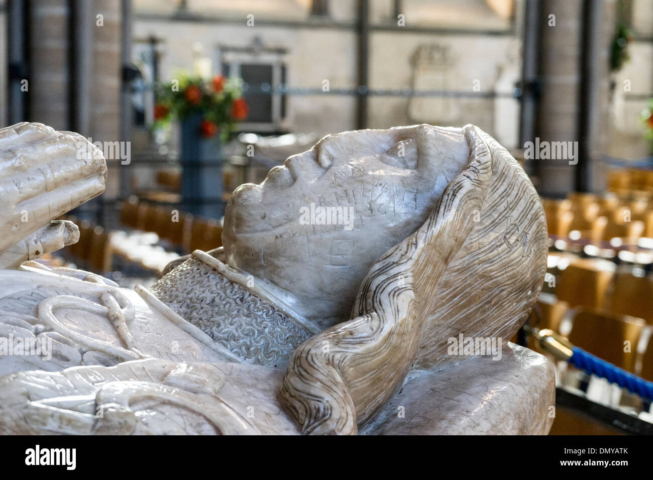 Medieval graffiti scratched into a carved marble figure on top of a tomb in Salisbury Cathedral UK Stock Photo
