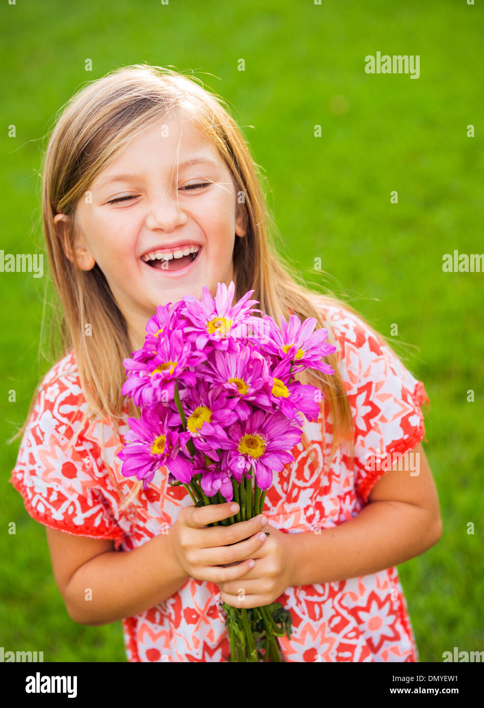 Portrait of a smiling cute little girl with flowers Stock Photo - Alamy