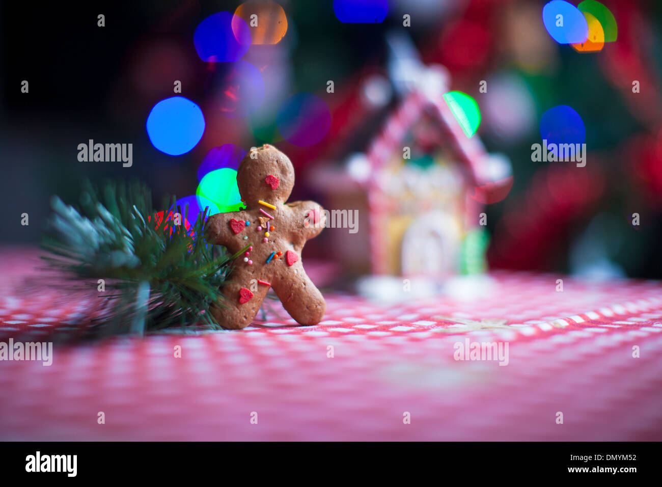 Gingerbread man in front of his candy ginger house background the
