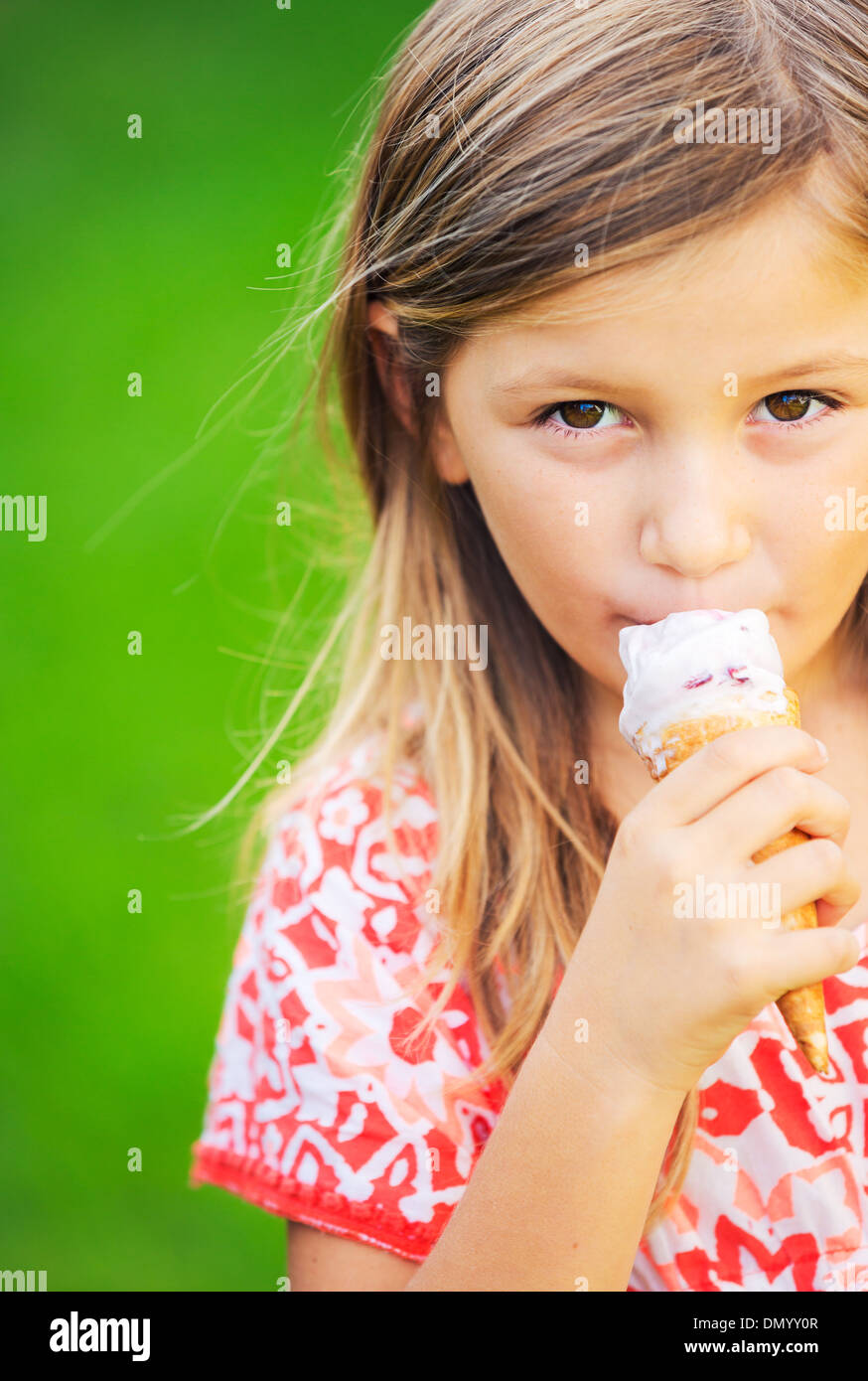 Happy cute little girl eating ice cream cone Stock Photo Alamy