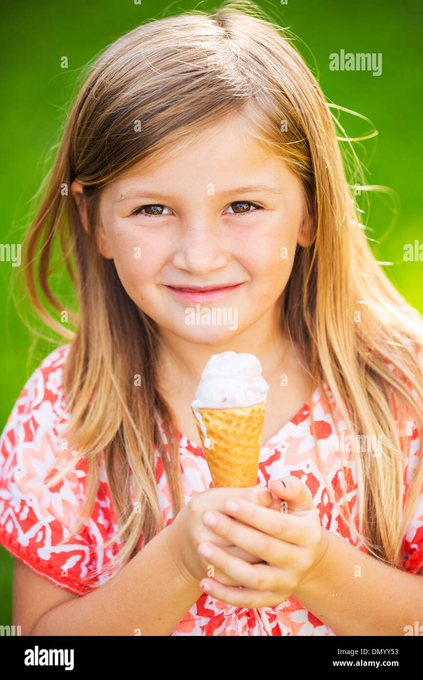 Happy cute little girl eating ice cream cone Stock Photo Alamy