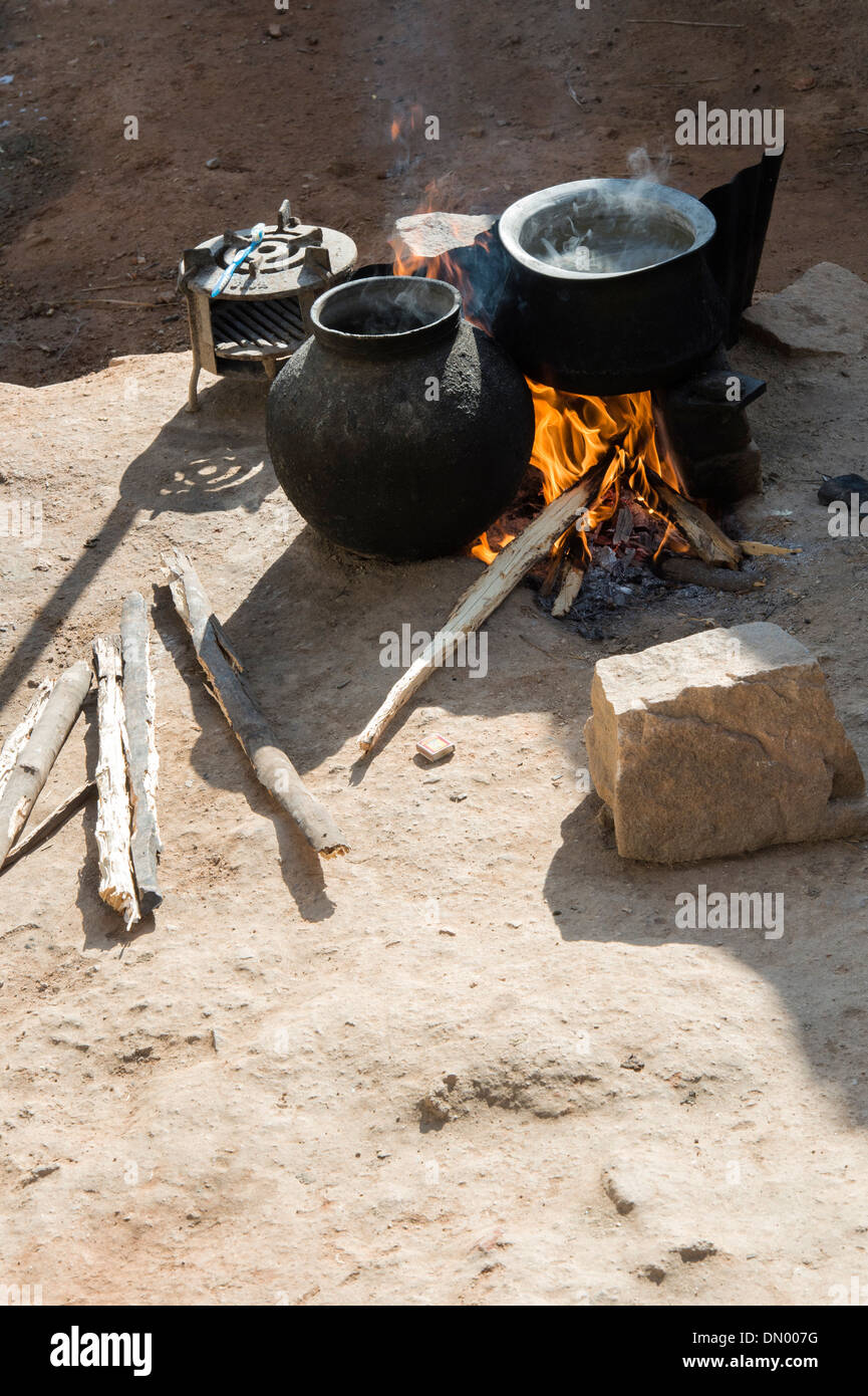 Boiling water on an open fire in a rural Indian village. Andhra Pradesh ...