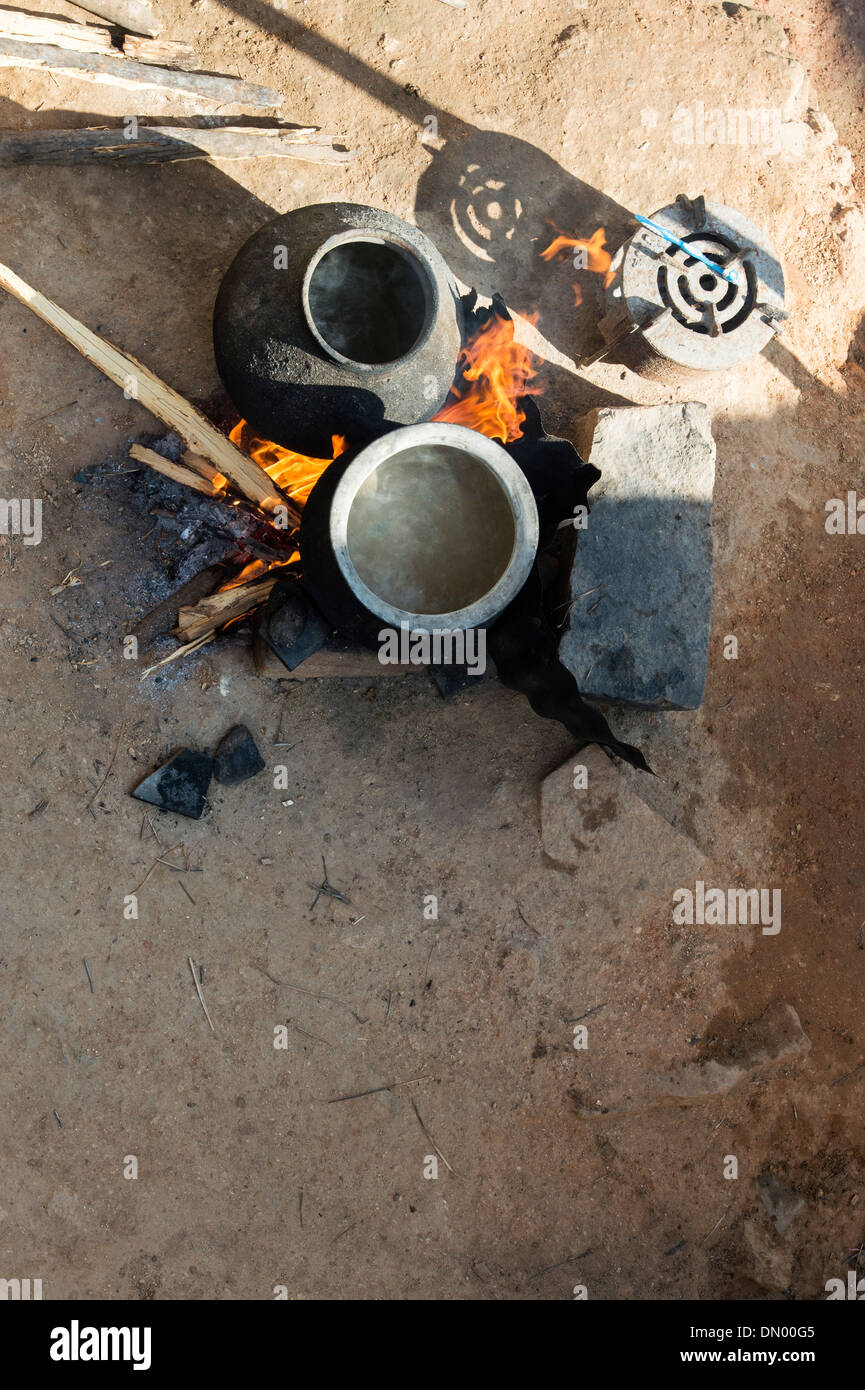 Boiling water on an open fire in a rural Indian village. Andhra Pradesh