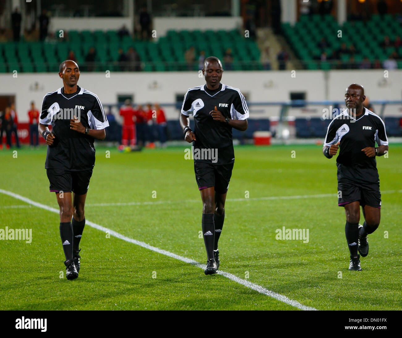 Agadir, Morocco. 17th Dec, 2013. Mr Referee (M) Mr Bakary GASSAMA (GAM) Asst Referee (L) ANGESOM OGBAMARIAM (ERT) and Asst Referee (R) EVARIST MENKOUANDE (CMR)warm up before the FIFA Club World Cup Semi Final between Guangzhou Evergrande and Bayern Munich from the Agadir Stadium. Credit:  Action Plus Sports/Alamy Live News Stock Photo