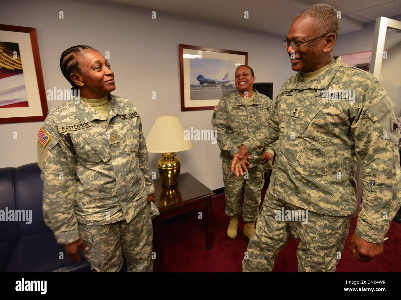 Washington, District of Columbia, US, USA. 17th Dec, 2013. ERROL R. SCHWARTZ, Commanding General, Joint Force Headquarters, District of Columbia National Guard, welcomes Sgt. SHARLEY PATTERSON and Sgt.CHARNICE WATERS as they arrive to the DC Armory for a homecoming ceremony for nearly 50 soldiers from D.C.'s Army National Guard 372nd Military Police Battalion. Both soldiers were returning from a 10-month deployment to Guantanamo Bay, Cuba, in support of Operation Enduring Freedom. Credit:  Miguel Juarez Lugo/ZUMAPRESS.com/Alamy Live News Stock Photo