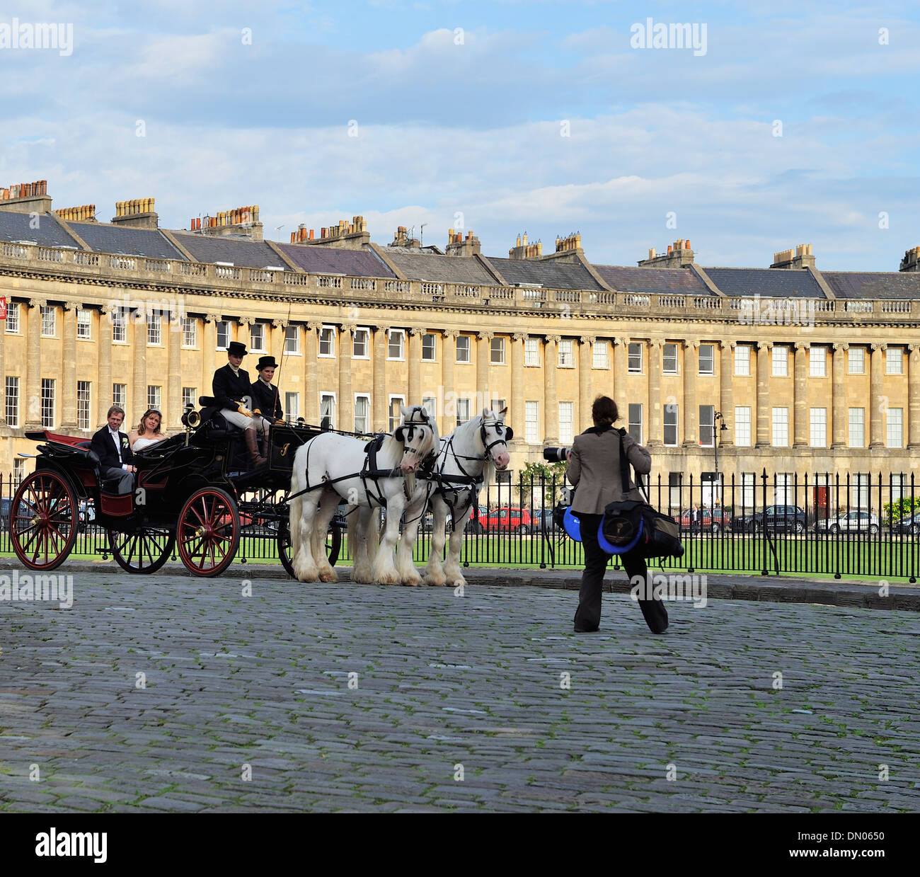 Wedding party and photographer at The Royal Crescent, Bath, England 130928 32159 Stock Photo