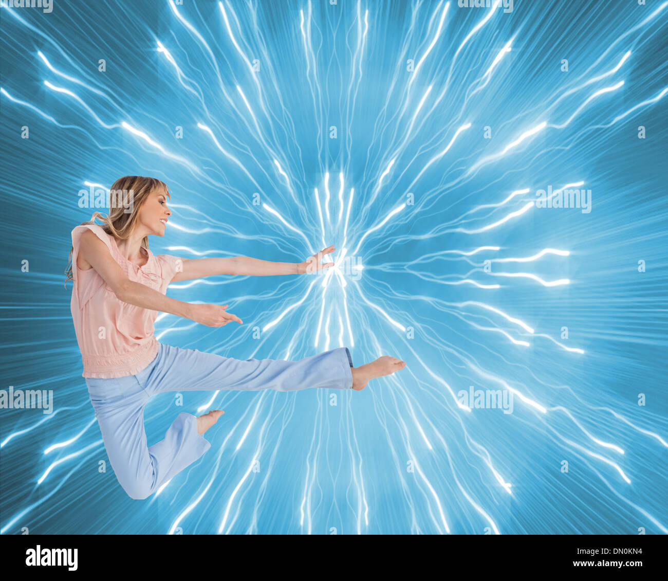 Composite image of woman doing dance pose Stock Photo