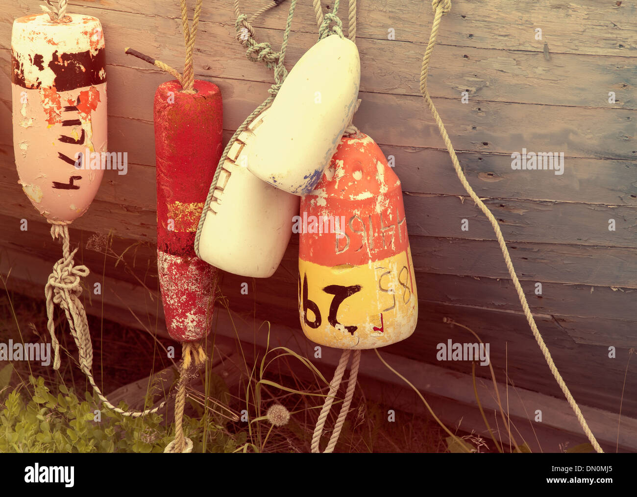 Old fishing buoy floats hanging off a wooden boat Stock Photo - Alamy