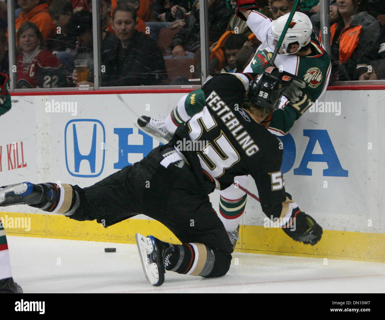 Minnesota Wild's Cal Clutterbuck, left, upends Chicago Blackhawks' Matt  Walker near center ice during the first period of an NHL Hockey game  Sunday, Feb. 22, 2009, in Chicago. (AP Photo/Jim Prisching Stock