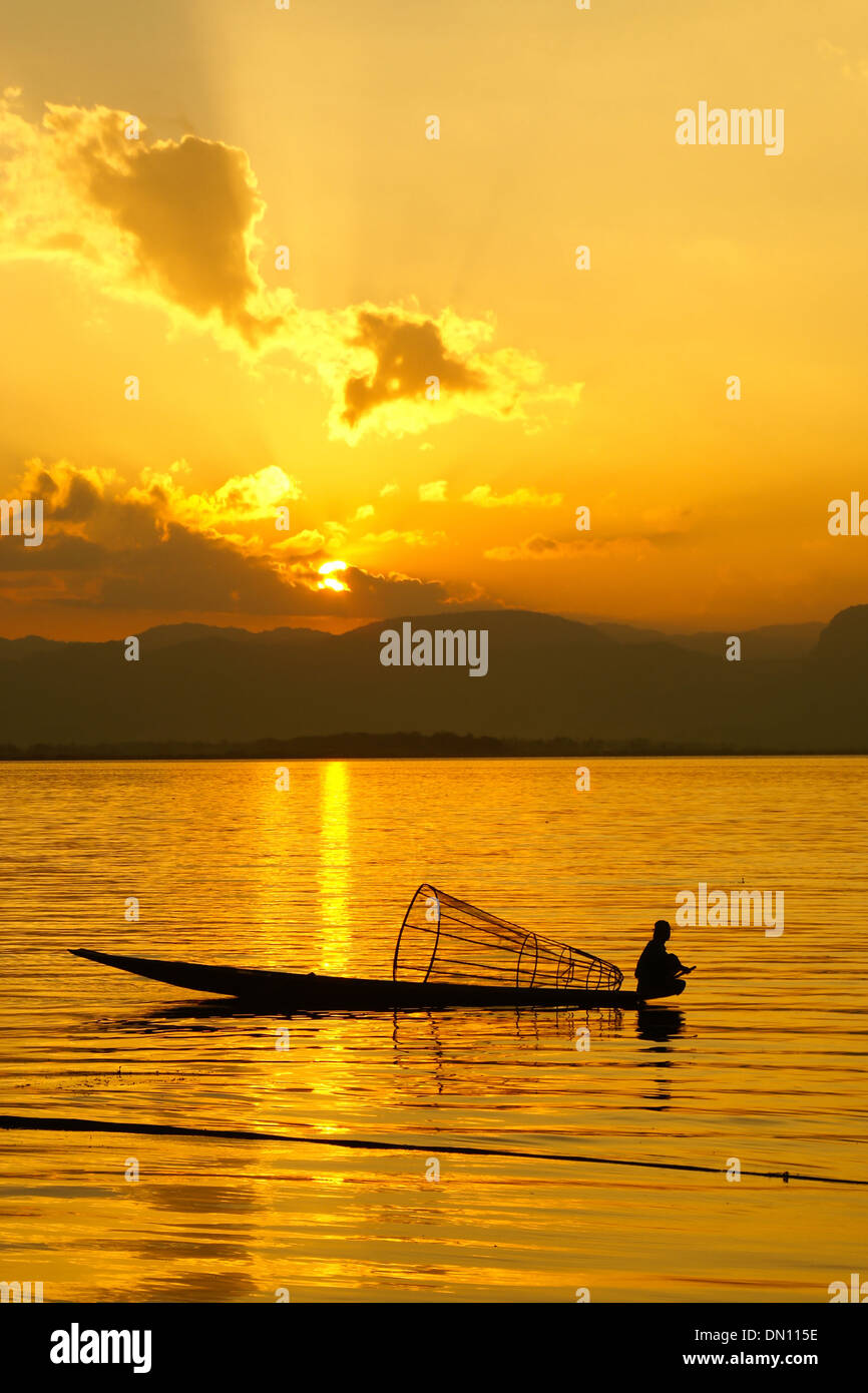 Sunset at Inle Lake with silhouette of fisherman, Myanmar, Asia Stock Photo