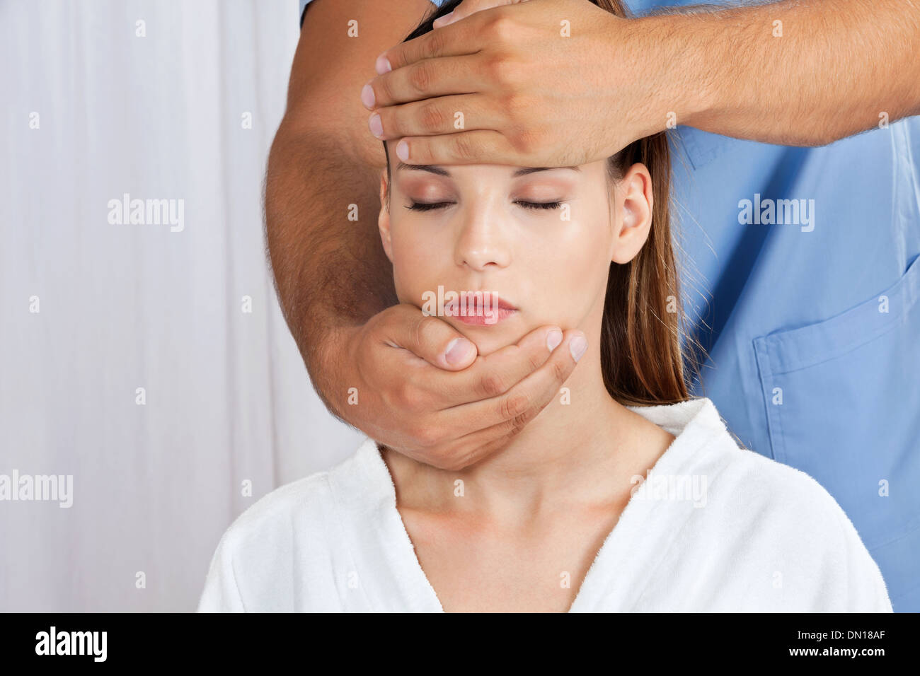 Masseuse Giving Head Massage To Woman Stock Photo