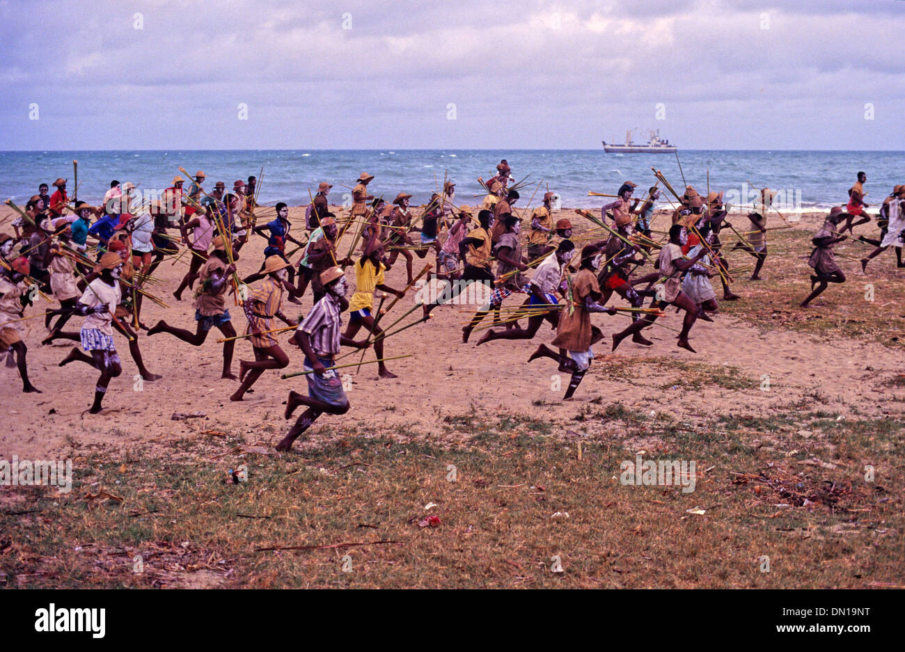 Mock Battle or Tribal Fight as Tribal Warriors of Antaimoro Tribe Charge on Beach during Sambatra Circumcision Festival Mananjary Madagascar Stock Photo