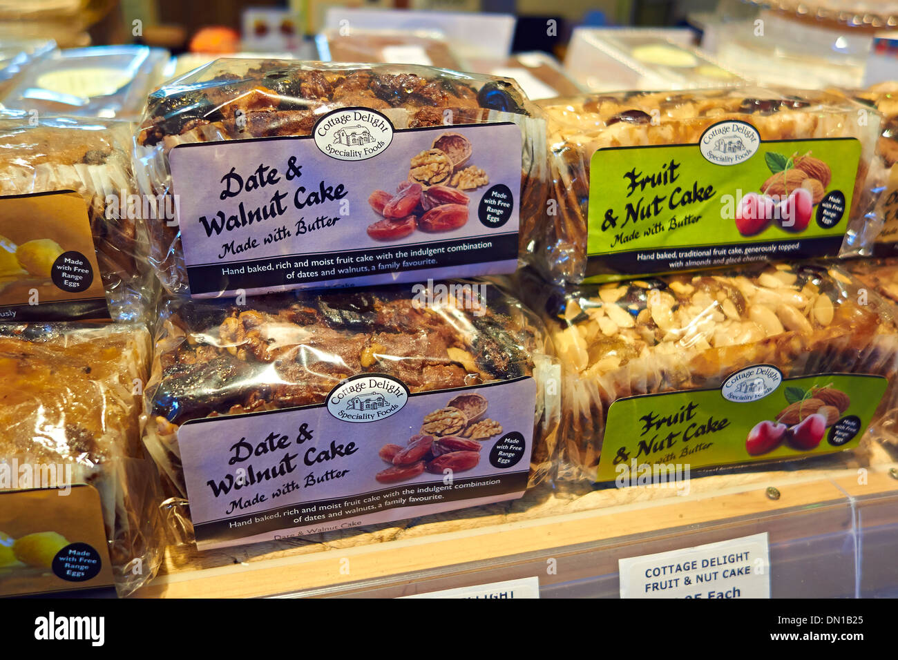 Date and walnut, fruit and nut cakes on display in a farm shop. Stock Photo