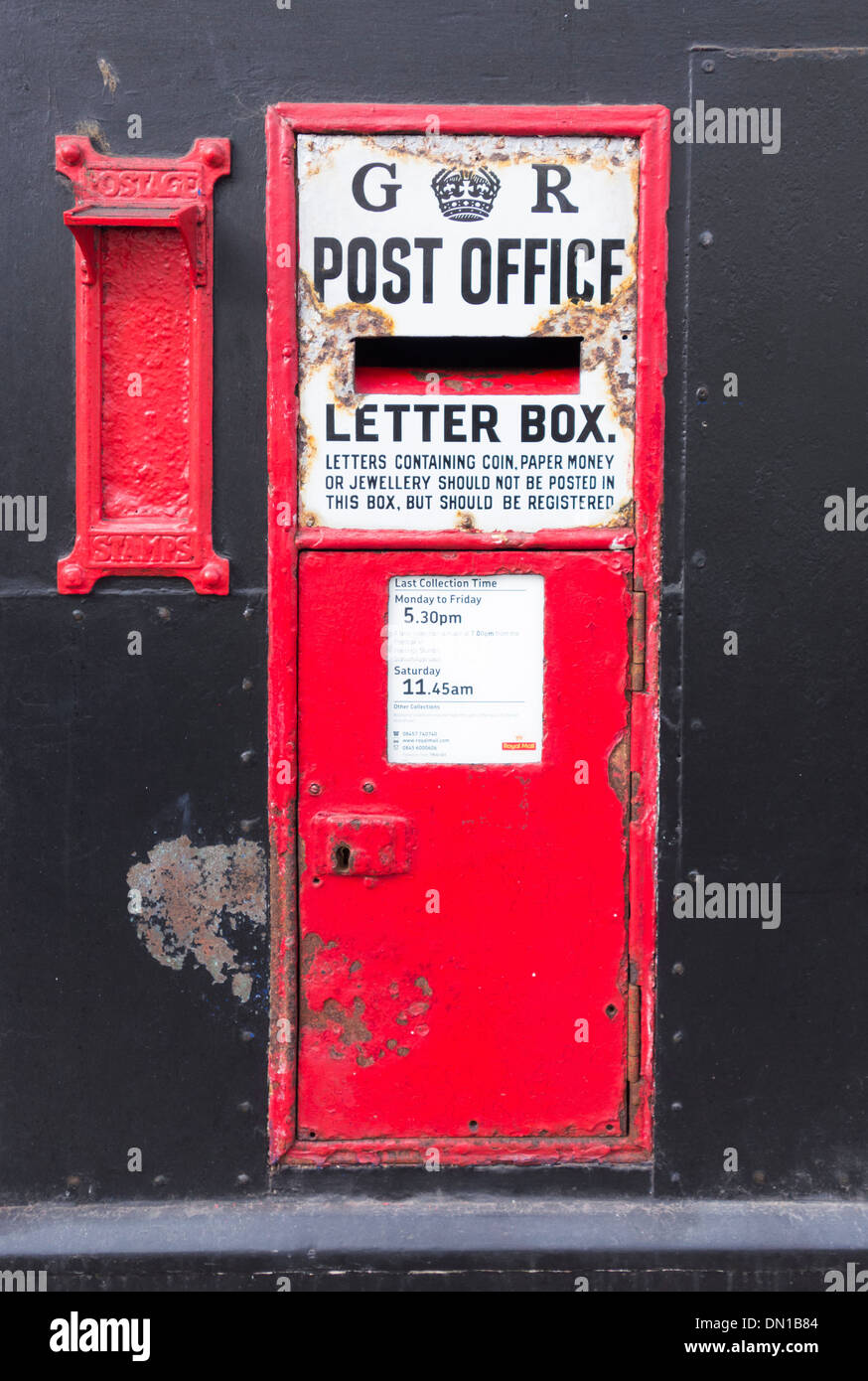 Traditional English King George VI red post box, High Street, Hastings, England, UK Stock Photo