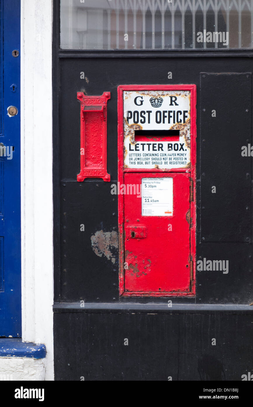 Traditional English King George VI red post box, High Street, Hastings, England, UK Stock Photo
