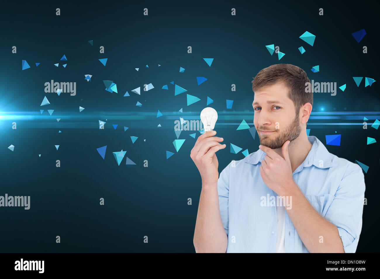 Composite image of handsome model holding a bulb Stock Photo