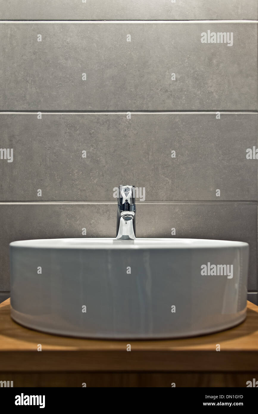 Elegant washbasin in bathroom with nice gray ceramic tiles Stock Photo
