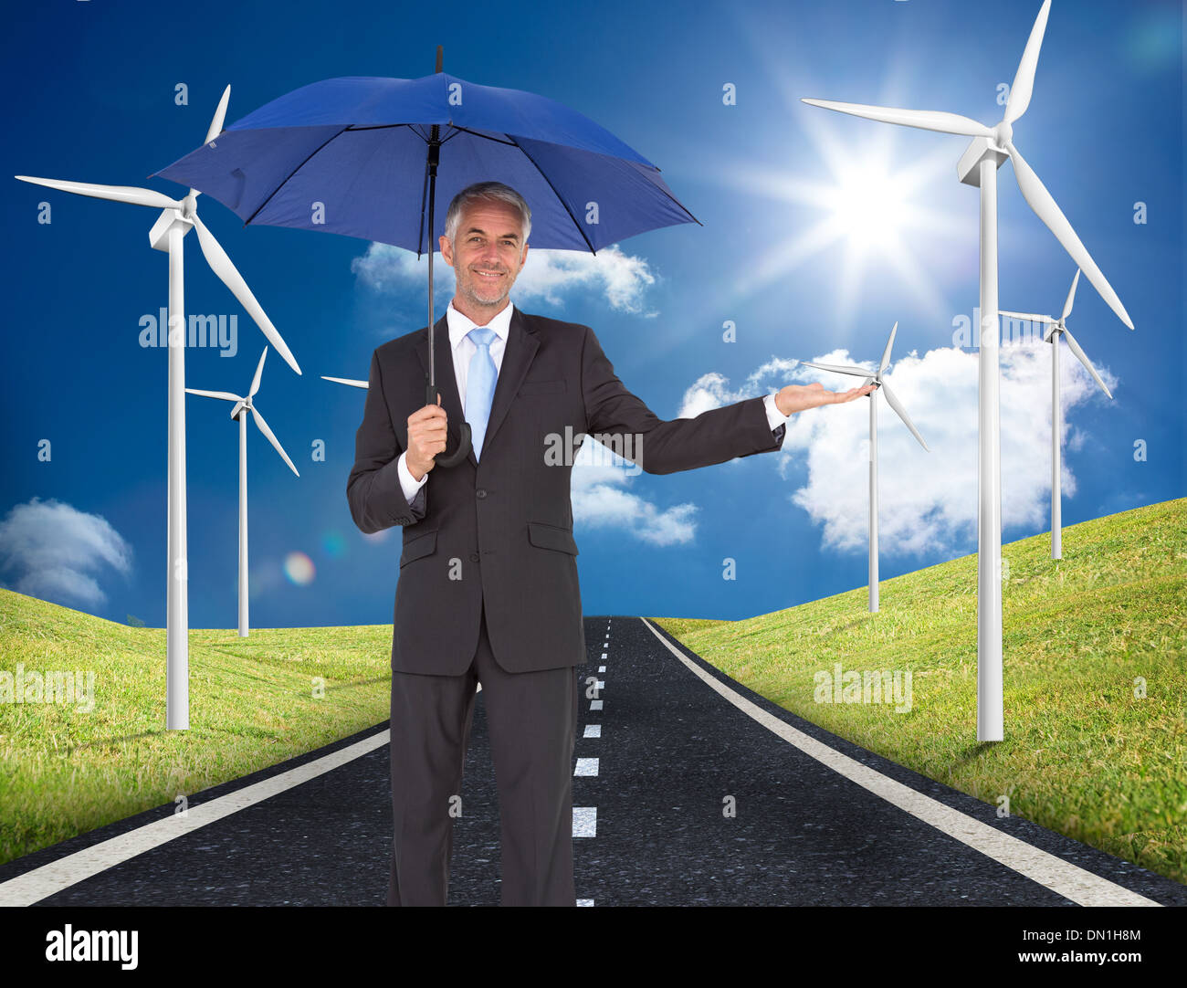 Composite image of peaceful businessman holding blue umbrella Stock Photo