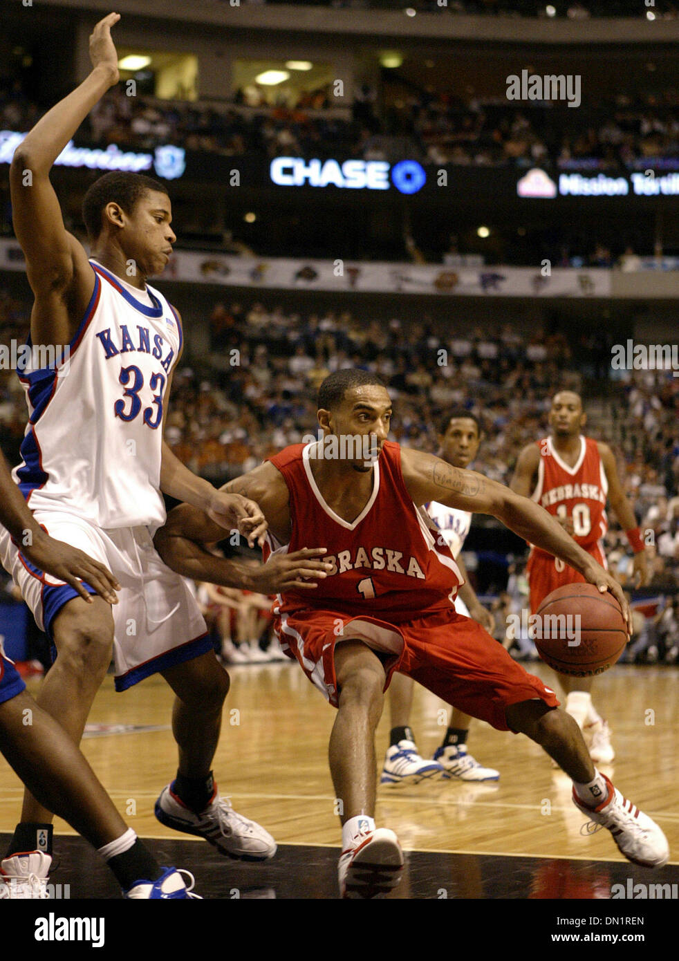 Mar 11, 2006; Dallas, TX, USA; NCAA BASKETBALL: Nebraska's Jason Dourisseau looks for room around Kansas' C.J. Giles during the 2006 Phillips 66 Big 12 Men's Championship Saturday March 11, 2006 at the American Airlines Center in Dallas. Mandatory Credit: Photo by EA Ornelas/San Antonio Express-News/ZUMA Press. (©) Copyright 2006 by San Antonio Express-News Stock Photo