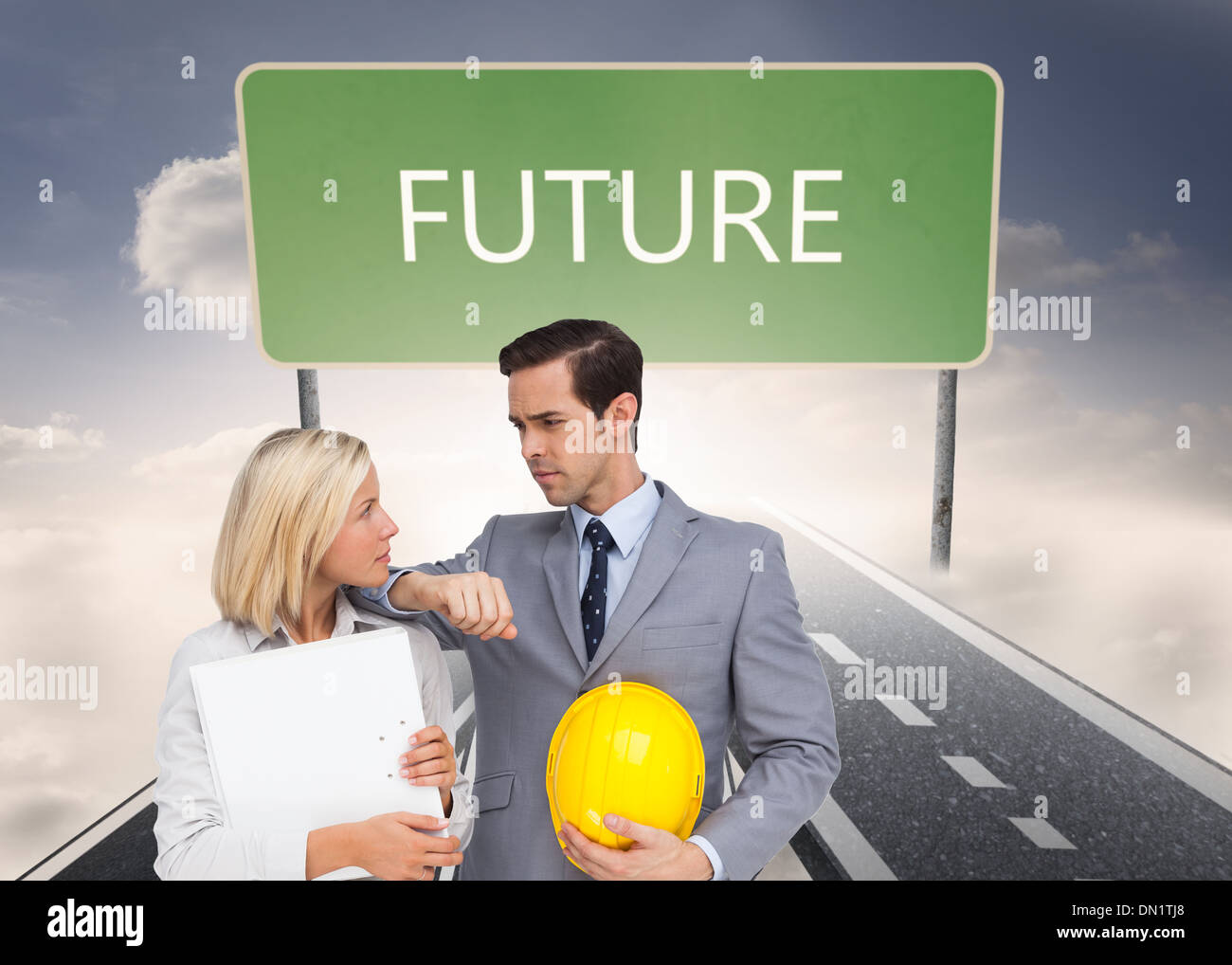 Composite image of architects with plans and hard hat looking at each other Stock Photo