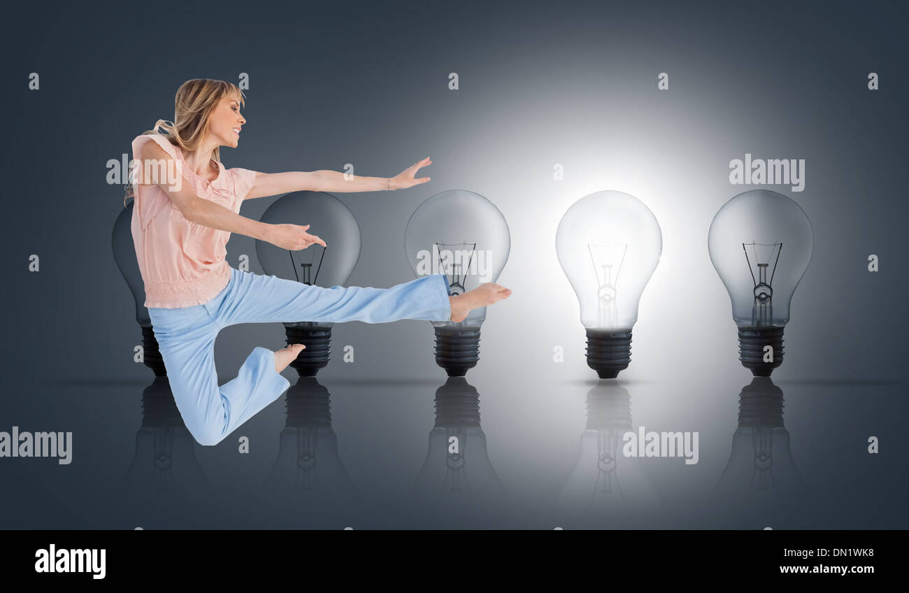 Composite image of woman doing dance pose Stock Photo