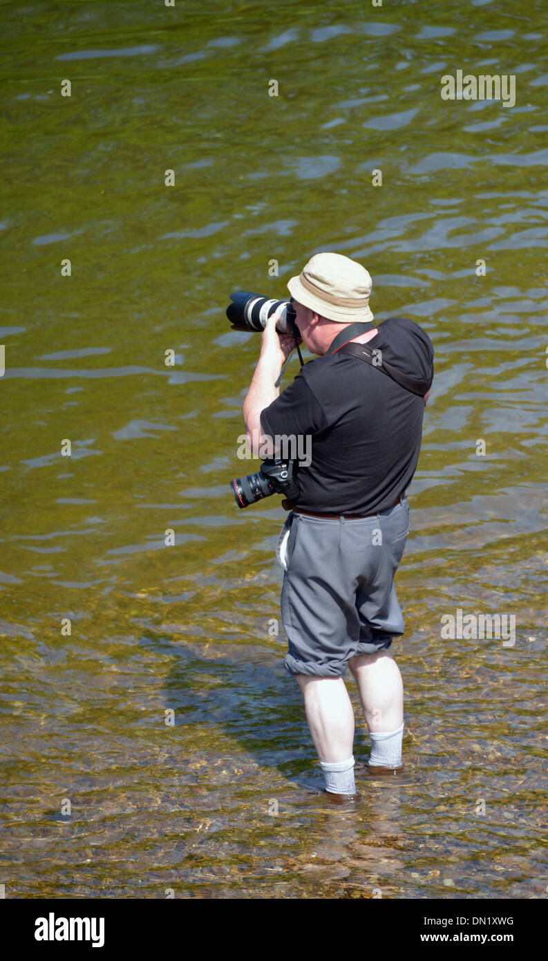Photographer standing in River Eden. Appleby Horse Fair, Appleby-in-Westmorland, Cumbria, England, United Kingdom, Europe. Stock Photo