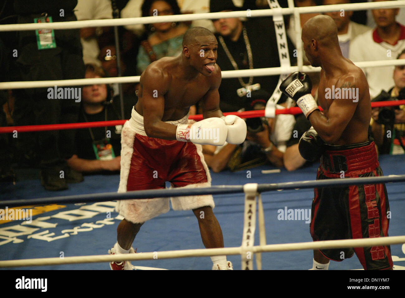 Apr 08, 2006; Las Vegas, NV, USA; FLOYD MAYWEATHER JR. vs ZAB JUDAH IBF Welterweight Fight. When JUDAH Punched MAYWEATHER below the belt  ROGER MAYWEATHER trainer & Uncle jumped into the ring & went after ZAB JUDAH. FLOYD MAYWEATHER JR ( L) taunts by sticking his tongue out at ZAB JUDAH (R) red & black trunks. Nevada athletic Chief Inspector TONY LATO  & inspectors in burgandy jack Stock Photo