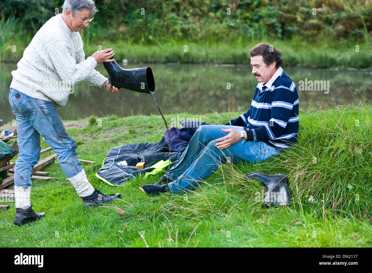removing a boot full of water Stock Photo Alamy