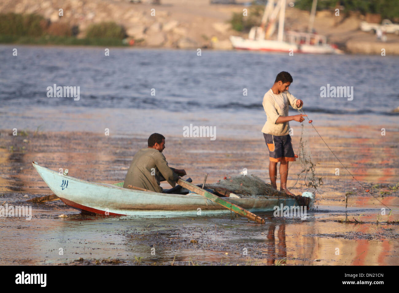 Two Fishermen spreading the net in the Nile .South of Cairo . Stock Photo