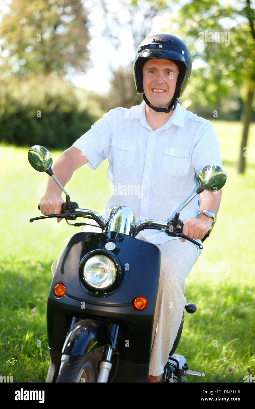 Man ride retro motorbike scooter Stock Photo Alamy