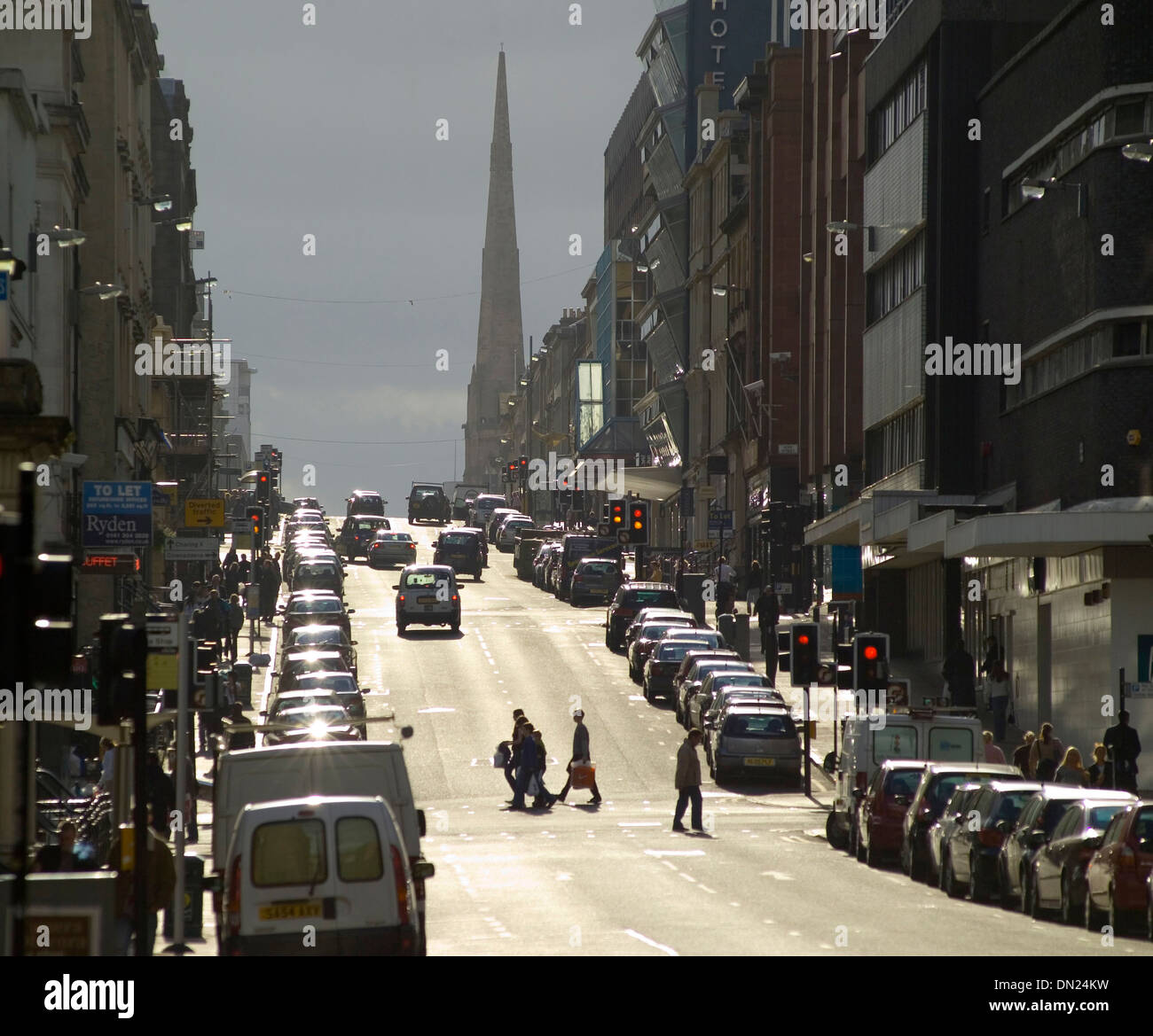 bath street in glasgow with dramatic light and stormy atmospheric with spire and pedestrians
