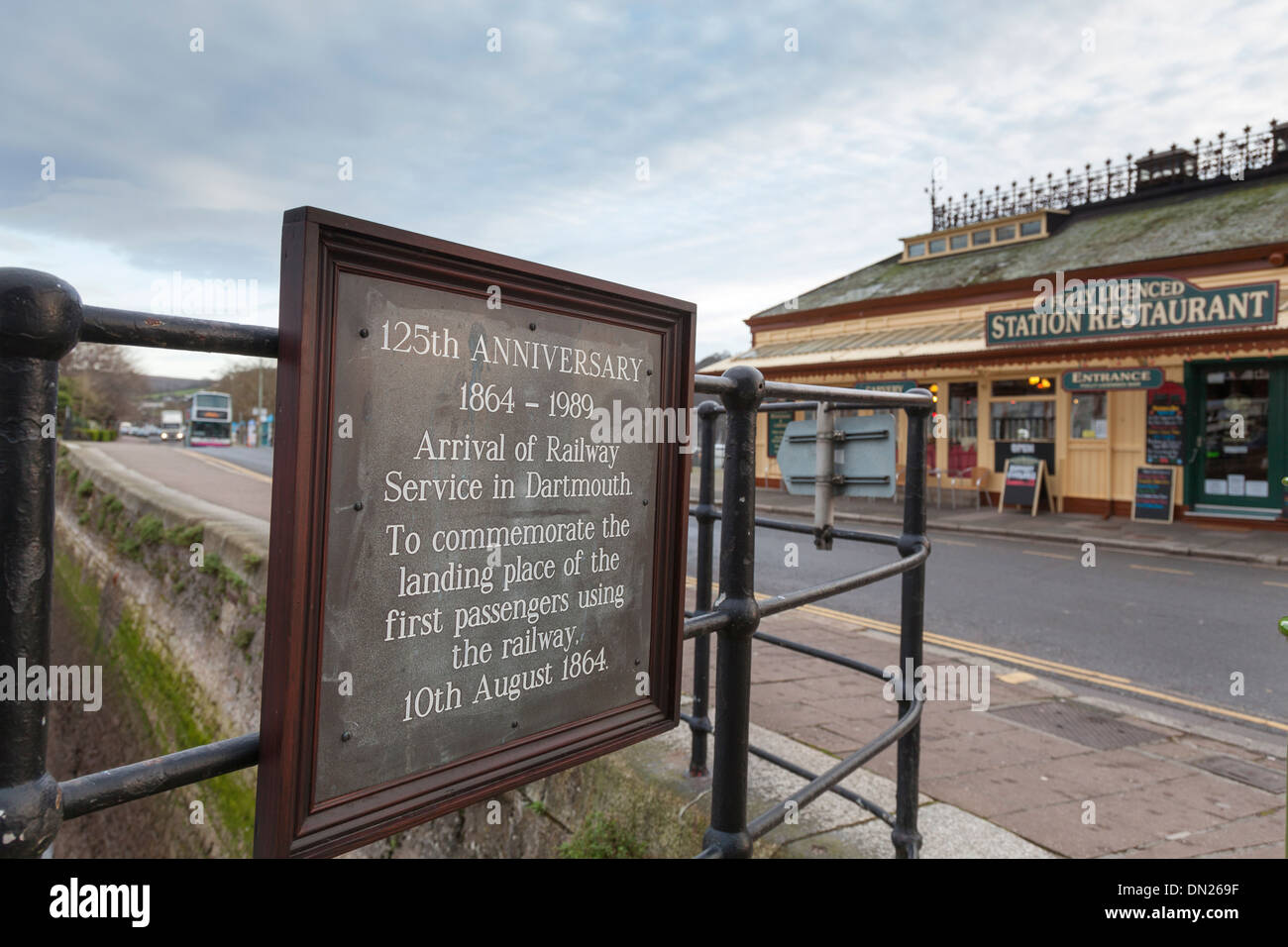 A plaque commemorates the first landing of railway passengers at Dartmouth station (now a restaurant) opposite. Stock Photo